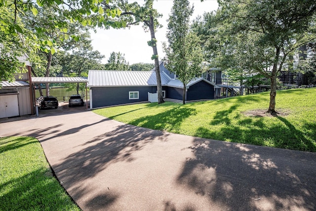 154 Bayside Cir, Malakoff, TX 75148 - view of front of house with a front yard, driveway, metal roof, and a detached carport