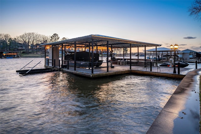 dock area with a water view and boat lift