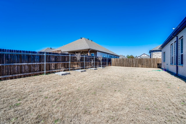 view of yard with a fenced backyard