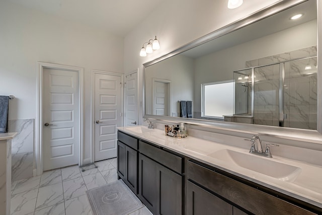 full bathroom featuring marble finish floor, a sink, a marble finish shower, and double vanity