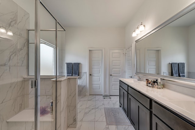 full bathroom with marble finish floor, a marble finish shower, and vanity