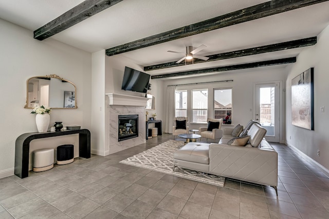 tiled living room featuring a healthy amount of sunlight, a fireplace, baseboards, and beamed ceiling