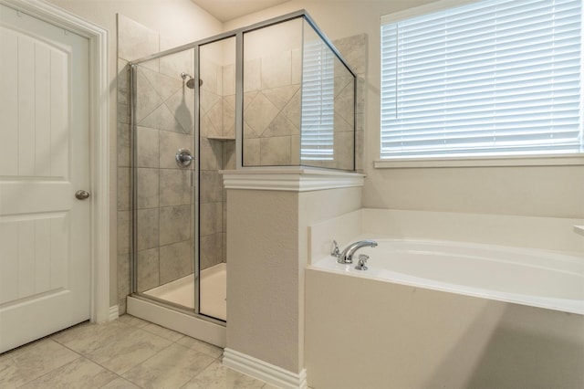 full bath featuring a stall shower and a garden tub