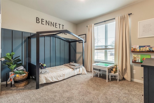 carpeted bedroom featuring baseboards