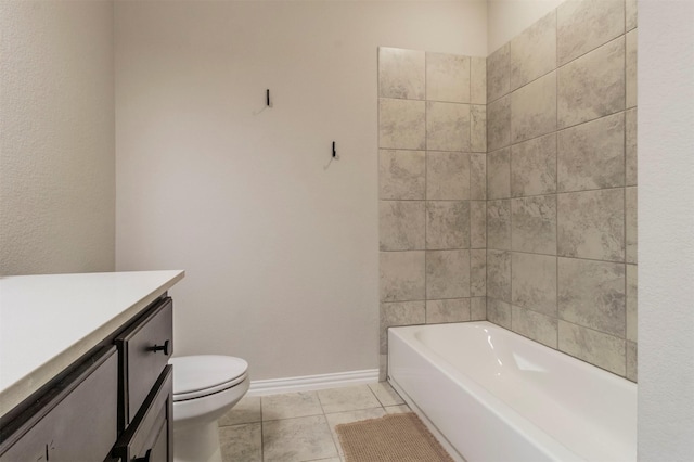 full bath featuring a washtub, toilet, vanity, baseboards, and tile patterned floors