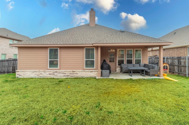 rear view of house featuring brick siding, a patio, a fenced backyard, and an outdoor hangout area