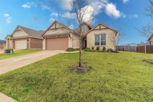 view of front facade with an attached garage, fence, concrete driveway, stone siding, and a front lawn