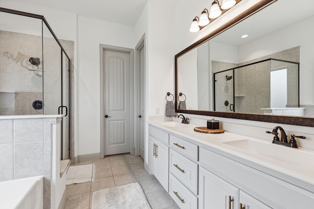 full bathroom featuring a stall shower, tile patterned flooring, a sink, and double vanity