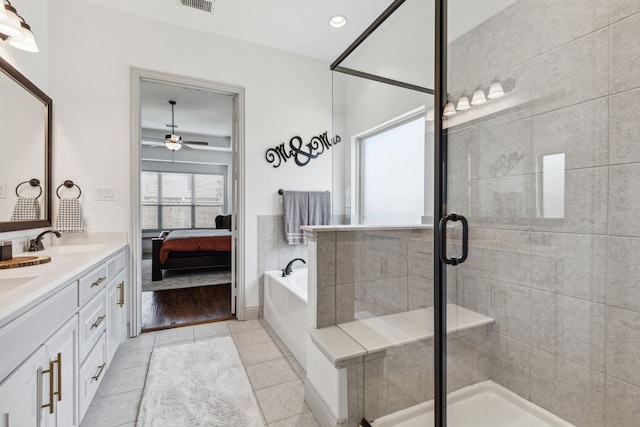 ensuite bathroom featuring a garden tub, double vanity, tile patterned flooring, and a shower stall