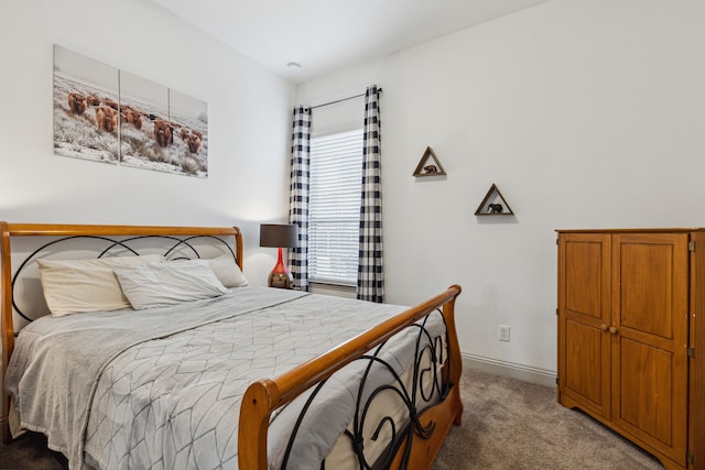 carpeted bedroom featuring baseboards