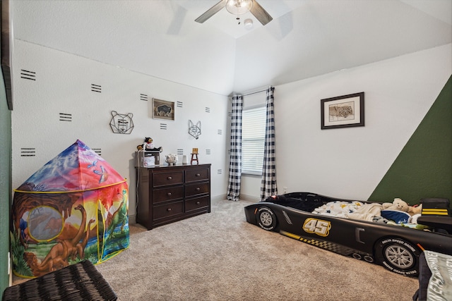 carpeted bedroom featuring lofted ceiling and a ceiling fan