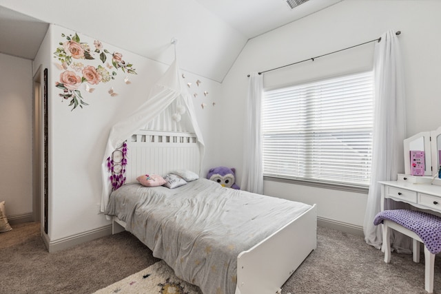 bedroom with lofted ceiling, multiple windows, light carpet, and baseboards