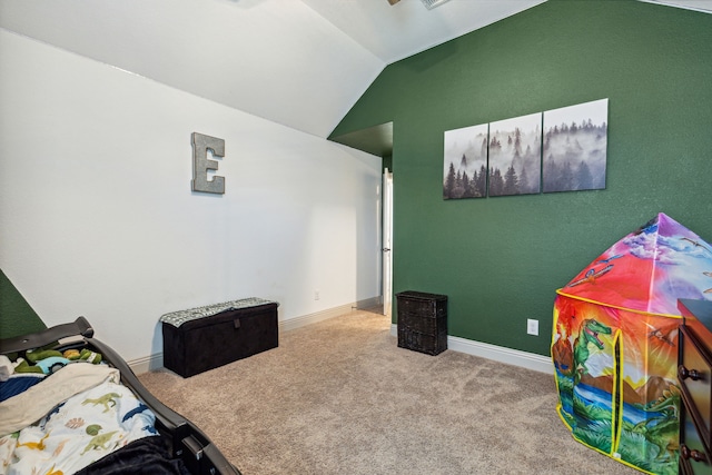 bedroom with carpet flooring, vaulted ceiling, and baseboards