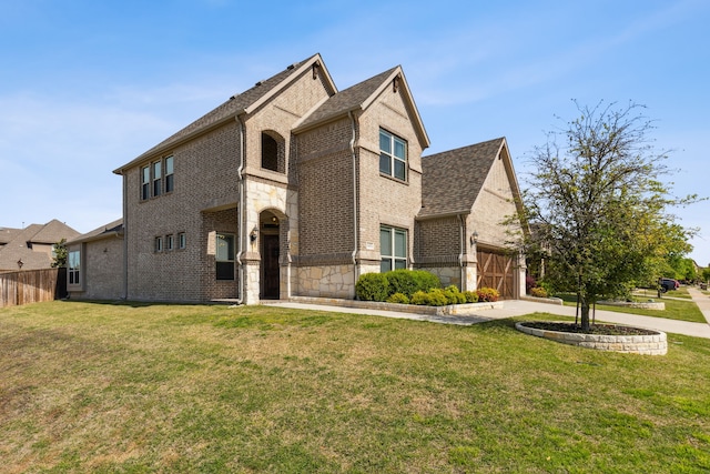 view of front of property featuring brick siding, concrete driveway, a front yard, fence, and stone siding