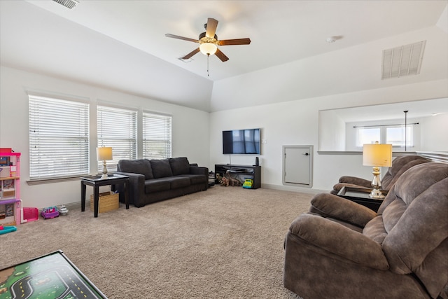 living area featuring carpet, visible vents, vaulted ceiling, ceiling fan, and baseboards