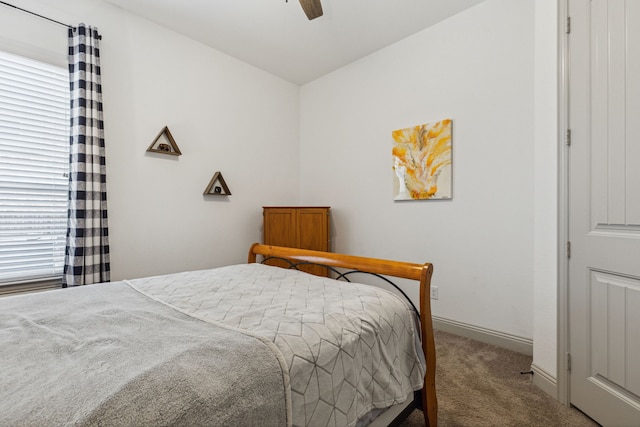 carpeted bedroom featuring ceiling fan and baseboards