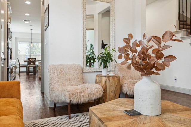 sitting room with baseboards, wood finished floors, and recessed lighting