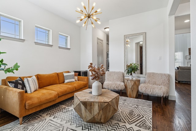 living area with a notable chandelier and wood finished floors