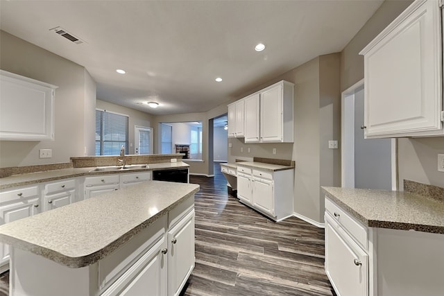 kitchen with recessed lighting, a sink, visible vents, black dishwasher, and dark wood-style floors