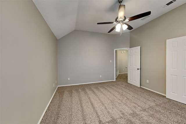 unfurnished bedroom with vaulted ceiling, carpet floors, and visible vents