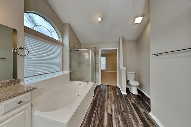 full bathroom featuring a garden tub, toilet, wood finished floors, vaulted ceiling, and a stall shower