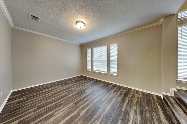 empty room with baseboards, crown molding, visible vents, and dark wood-style flooring