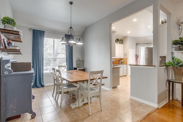 dining space featuring lofted ceiling, recessed lighting, light tile patterned flooring, and baseboards