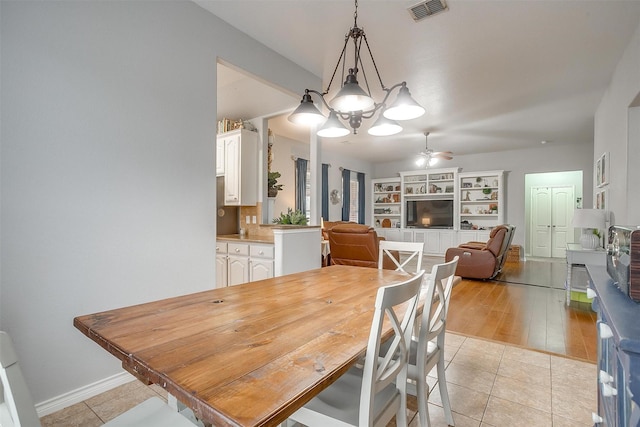 dining room featuring light tile patterned floors, baseboards, visible vents, and a ceiling fan