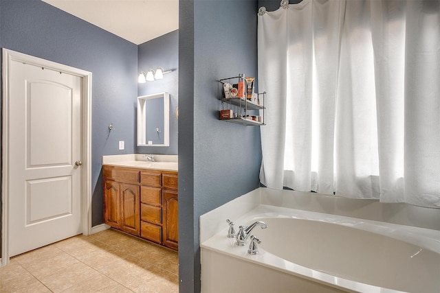 full bathroom with vanity, a bath, and tile patterned floors