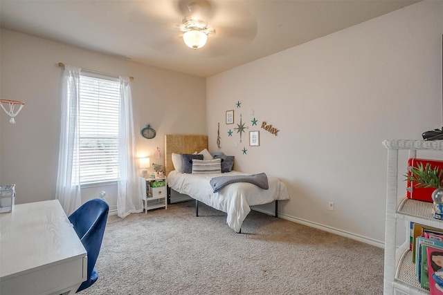 bedroom with ceiling fan, baseboards, and carpet flooring