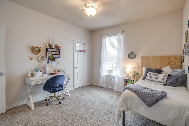 carpeted bedroom with baseboards