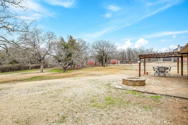 view of yard featuring a patio, an outdoor fire pit, and a pergola