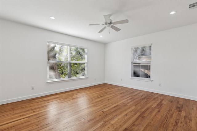 empty room featuring recessed lighting, visible vents, ceiling fan, light wood-type flooring, and baseboards