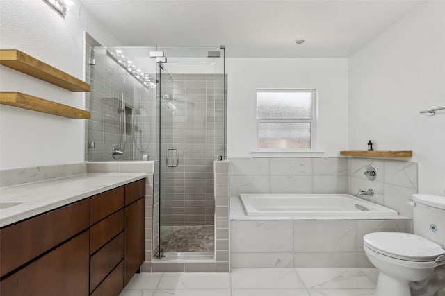 bathroom featuring a stall shower, marble finish floor, a garden tub, and toilet