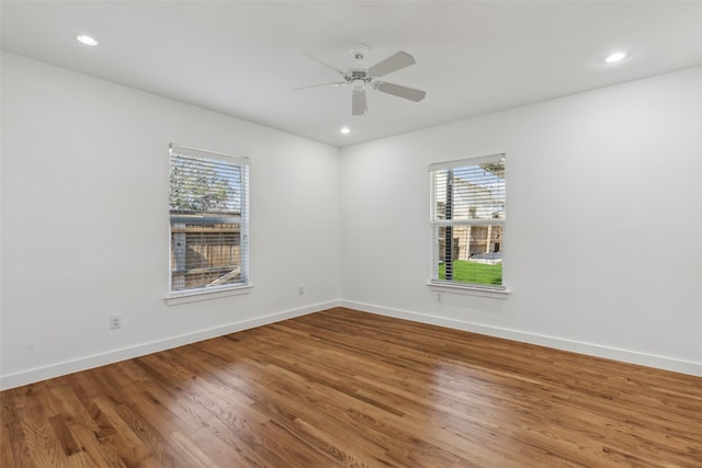 unfurnished room with recessed lighting, baseboards, and wood finished floors