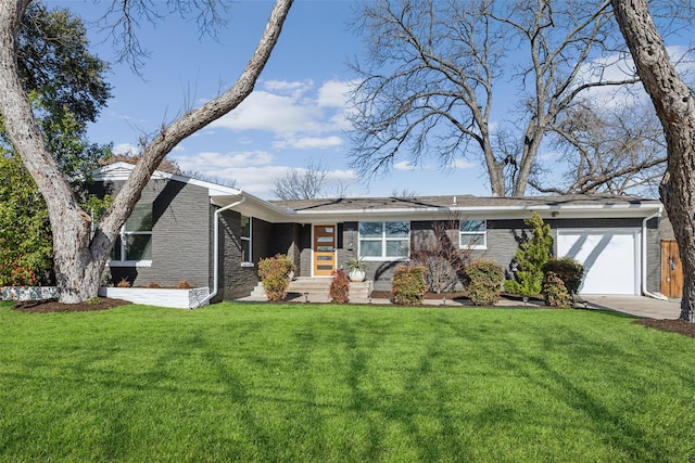 view of front facade featuring a garage, a front lawn, and brick siding