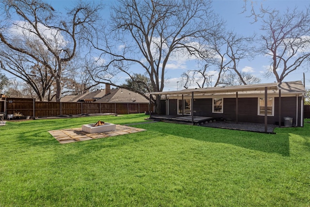 view of yard featuring an outdoor fire pit, a fenced backyard, and a wooden deck