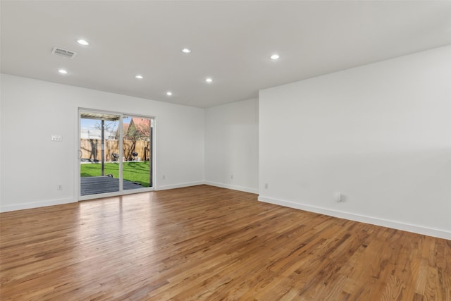 spare room featuring baseboards, light wood finished floors, visible vents, and recessed lighting