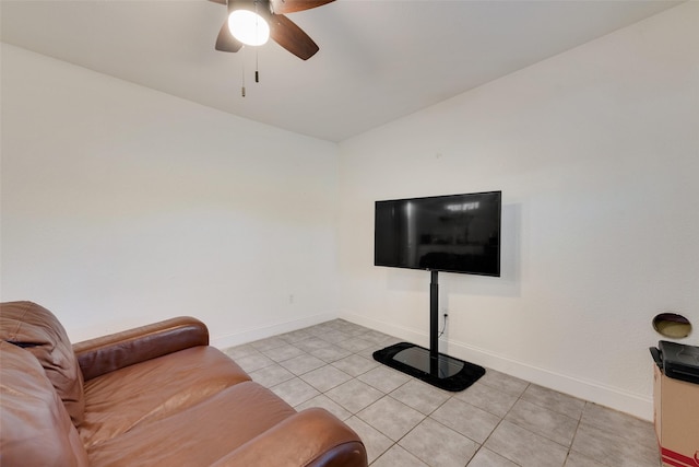 living area with light tile patterned flooring, ceiling fan, and baseboards