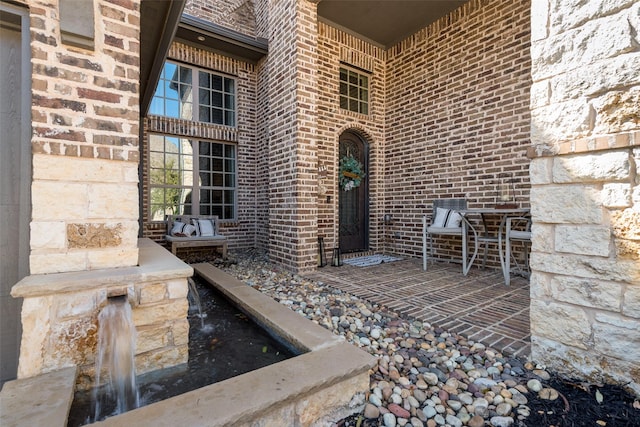 property entrance with brick siding