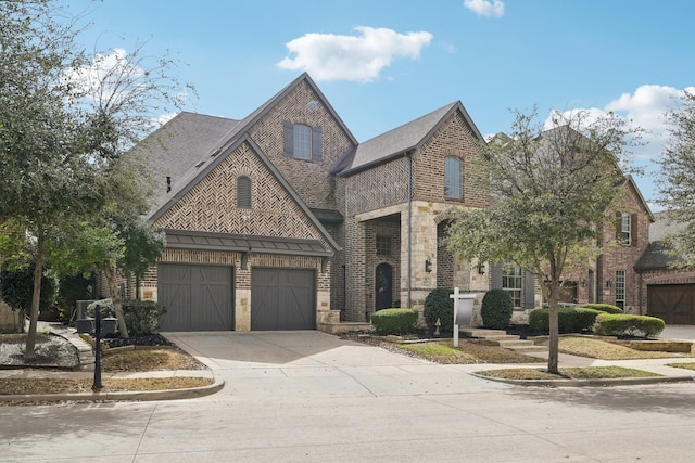 view of front of home with a garage, stone siding, brick siding, and concrete driveway