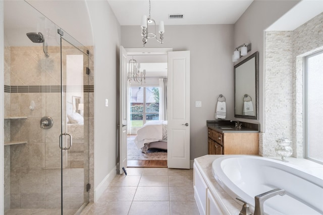 full bathroom with tile patterned flooring, vanity, visible vents, a shower stall, and ensuite bath