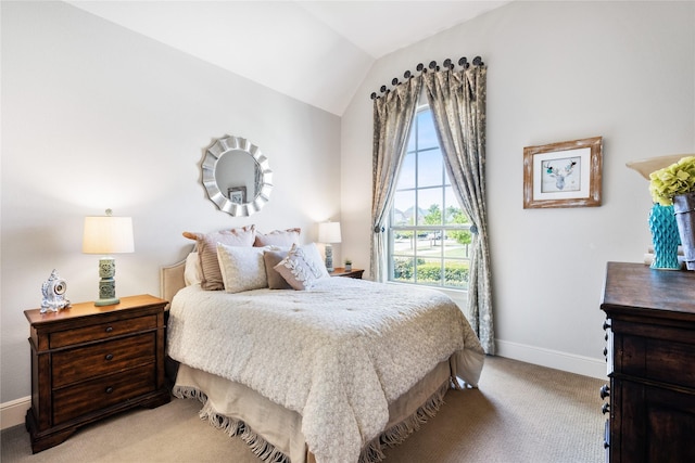 bedroom featuring multiple windows, vaulted ceiling, light carpet, and baseboards