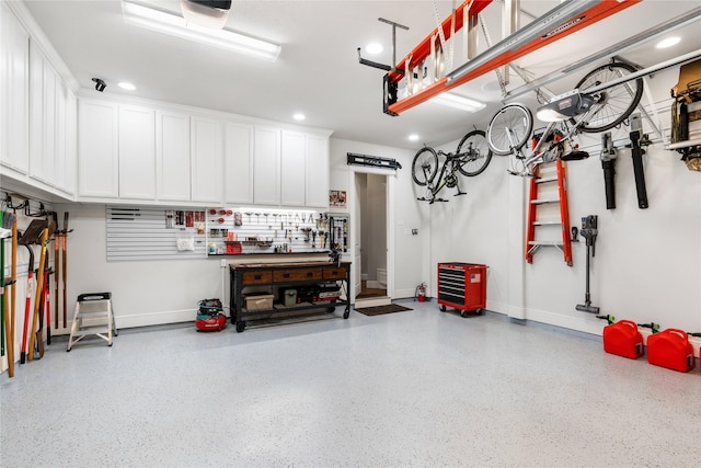 garage featuring recessed lighting and baseboards