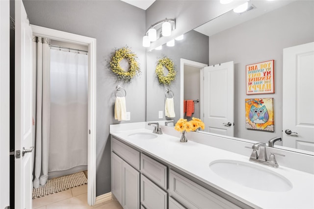 full bath with double vanity, tile patterned flooring, visible vents, and a sink