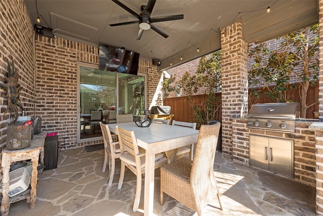 view of patio / terrace with grilling area, outdoor dining space, fence, ceiling fan, and exterior kitchen