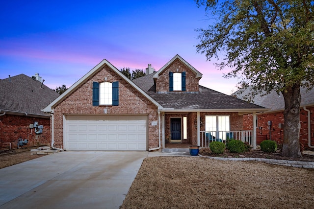 traditional-style house featuring concrete driveway, covered porch, brick siding, and a shingled roof