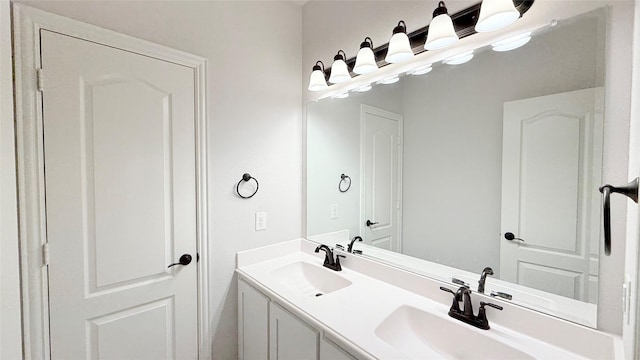 bathroom with a sink and double vanity