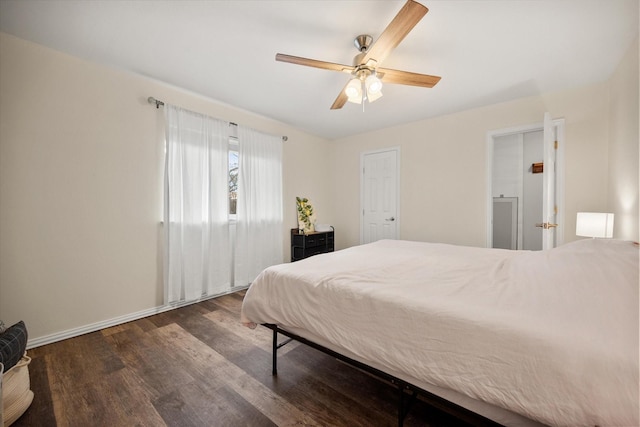 bedroom with ceiling fan, wood finished floors, and baseboards