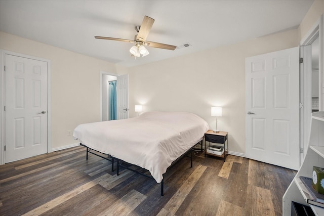 bedroom featuring dark wood-type flooring, ceiling fan, and baseboards